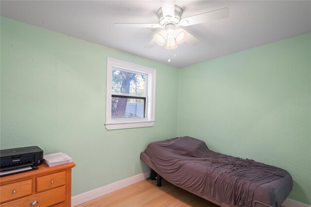 bedroom with ceiling fan and light hardwood / wood-style flooring