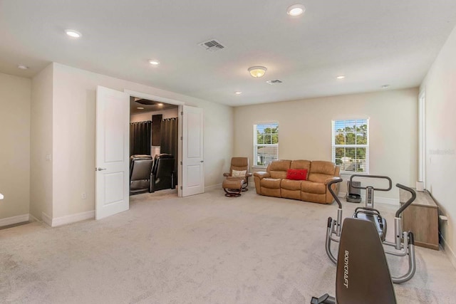 exercise room featuring light colored carpet