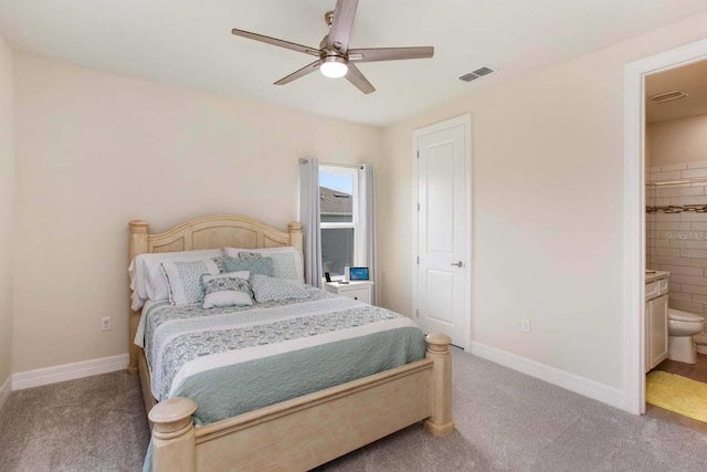 bedroom with ensuite bath, ceiling fan, and carpet floors