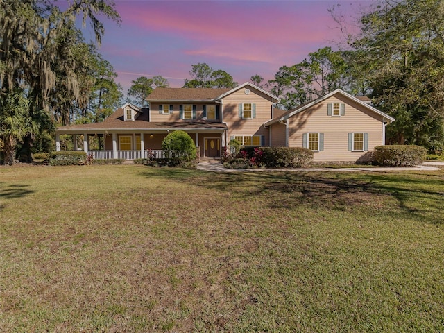 view of front facade with a yard and a porch