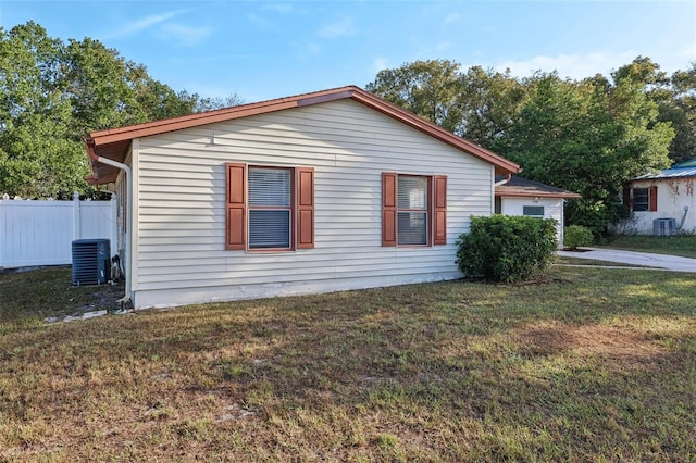 view of home's exterior featuring central AC and a lawn