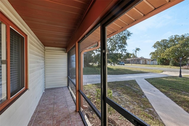 unfurnished sunroom with wood ceiling