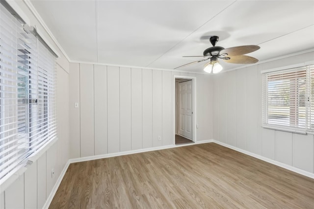 spare room with ceiling fan, light hardwood / wood-style floors, and crown molding