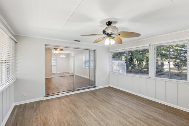 unfurnished sunroom featuring ceiling fan and plenty of natural light