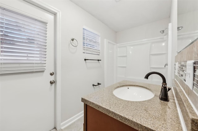 bathroom with plenty of natural light, a shower, and vanity