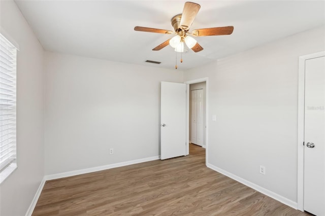 empty room featuring wood-type flooring and ceiling fan