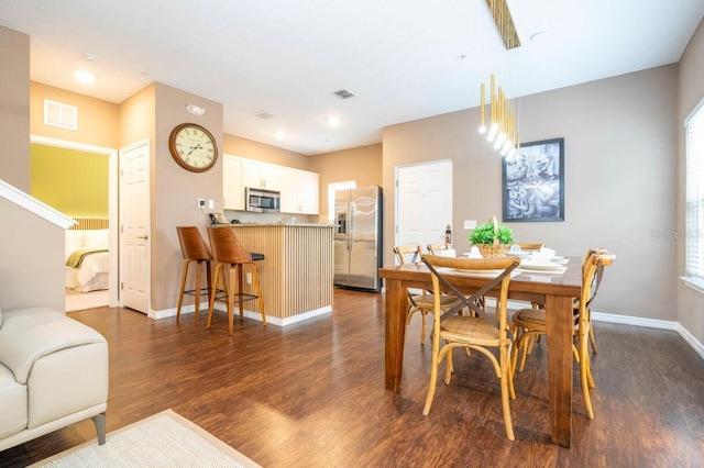 dining area with dark wood-type flooring