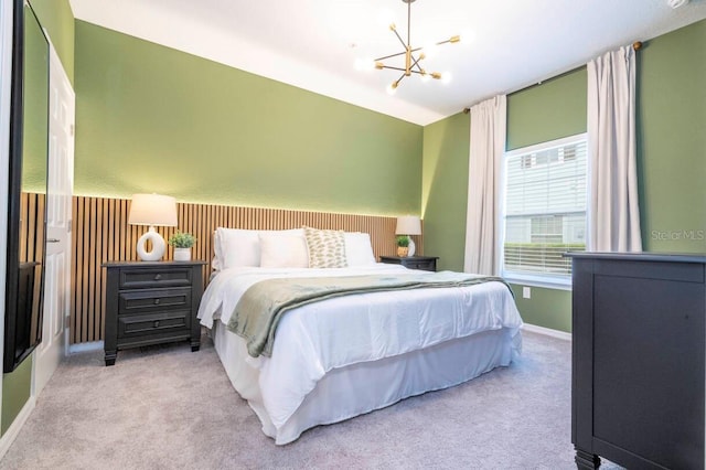 bedroom featuring light carpet and a chandelier