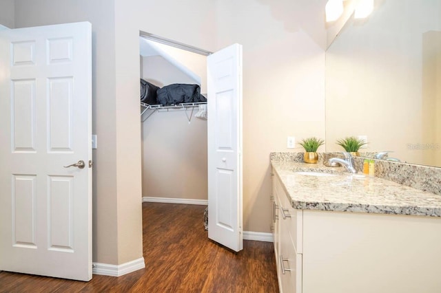 bathroom with hardwood / wood-style floors and vanity