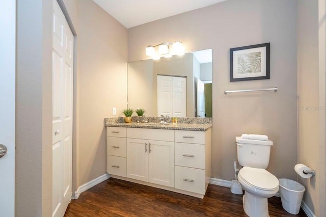 bathroom featuring hardwood / wood-style floors, vanity, and toilet