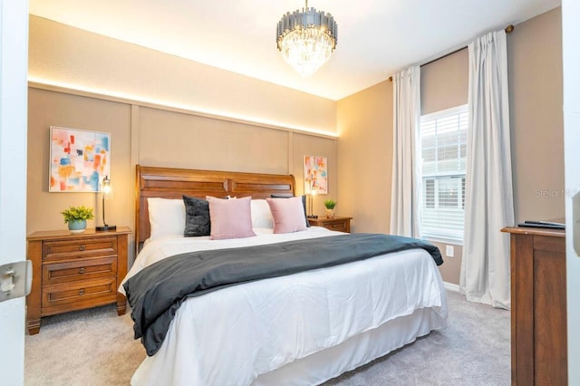 carpeted bedroom featuring a chandelier