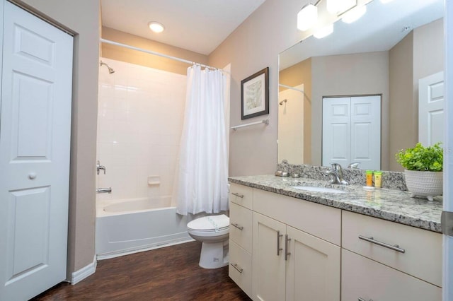 full bathroom with hardwood / wood-style floors, vanity, shower / bath combination with curtain, and toilet