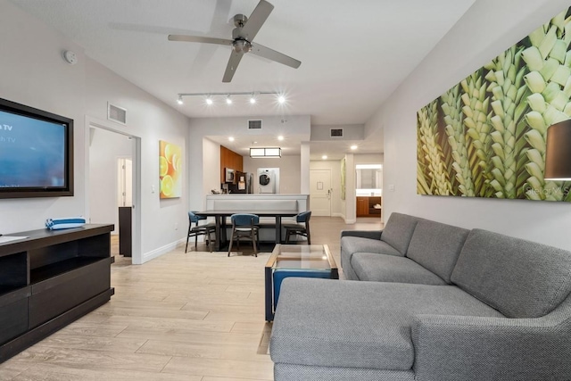 living room featuring ceiling fan, track lighting, and light hardwood / wood-style flooring