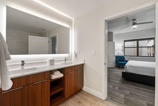 bathroom with vanity, hardwood / wood-style flooring, and ceiling fan