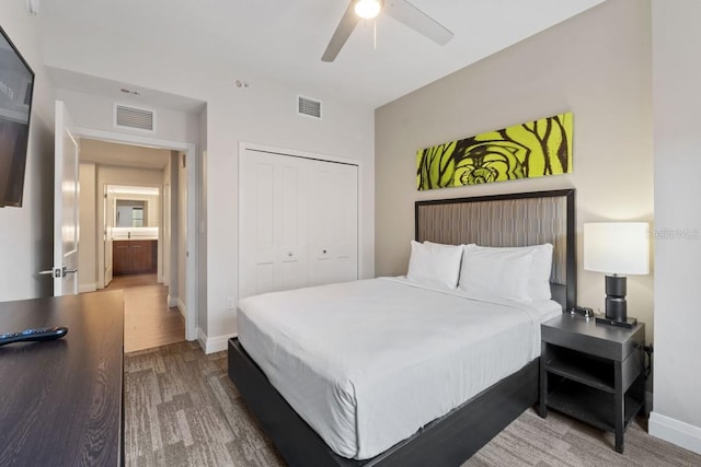 bedroom with ensuite bath, ceiling fan, a closet, and wood-type flooring