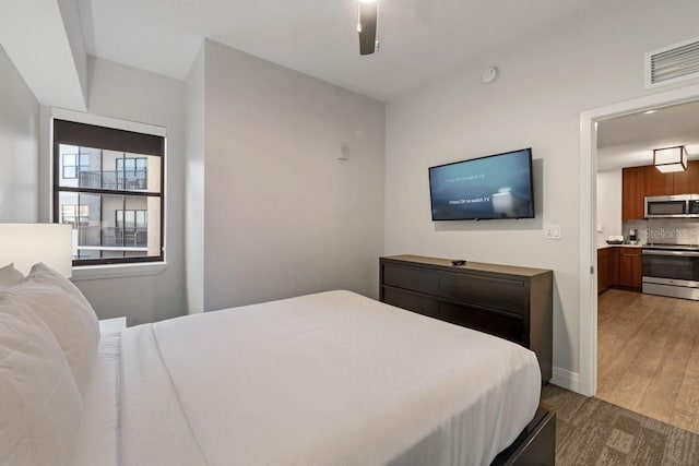 bedroom featuring wood-type flooring and ceiling fan