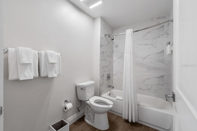 bathroom with hardwood / wood-style floors, shower / bath combo, and toilet