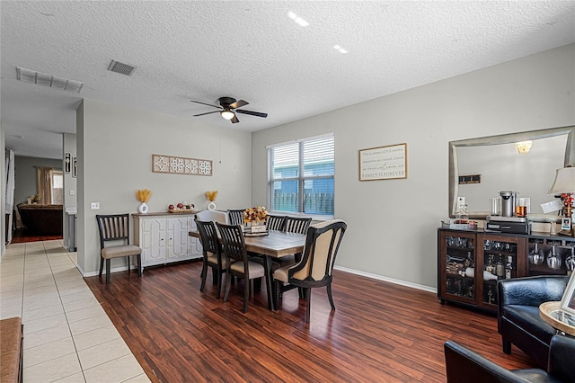 dining room featuring a textured ceiling and hardwood / wood-style flooring