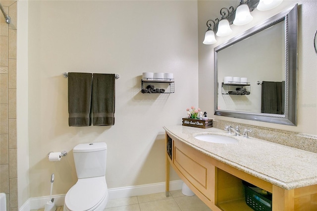 bathroom featuring tile patterned floors, vanity, and toilet