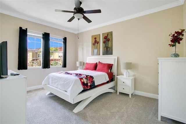 carpeted bedroom with ceiling fan and crown molding