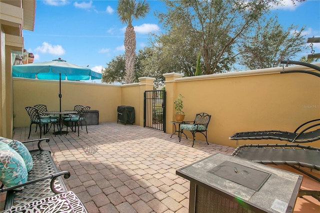 view of patio with a fire pit and grilling area