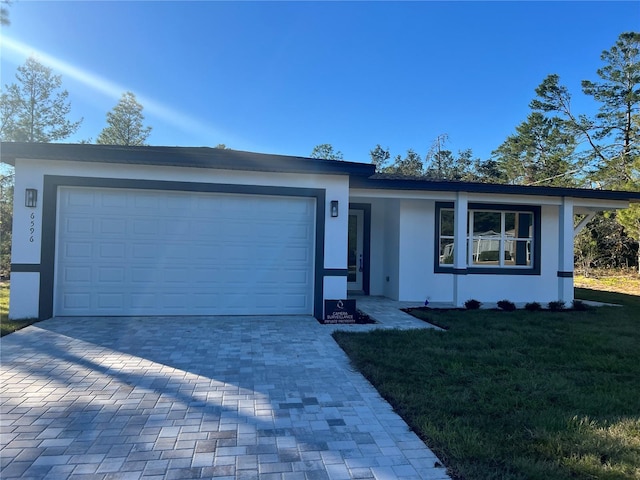 single story home featuring a front yard and a garage