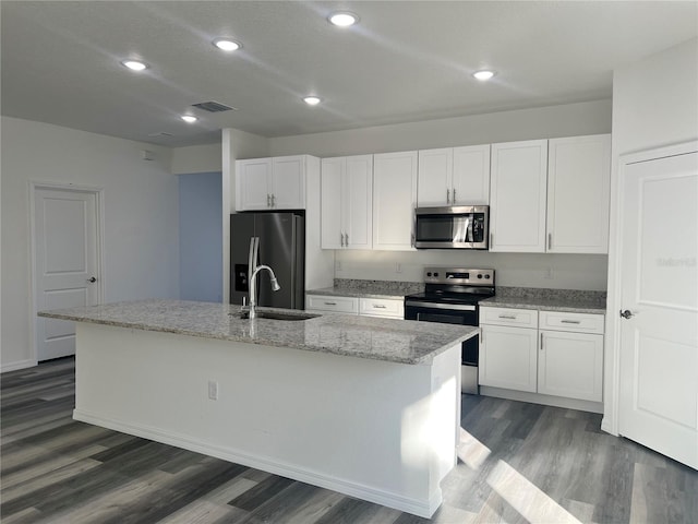 kitchen with a center island with sink, white cabinets, sink, and appliances with stainless steel finishes