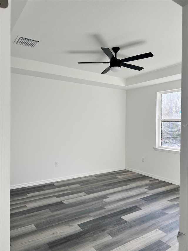 empty room with dark hardwood / wood-style floors and ceiling fan