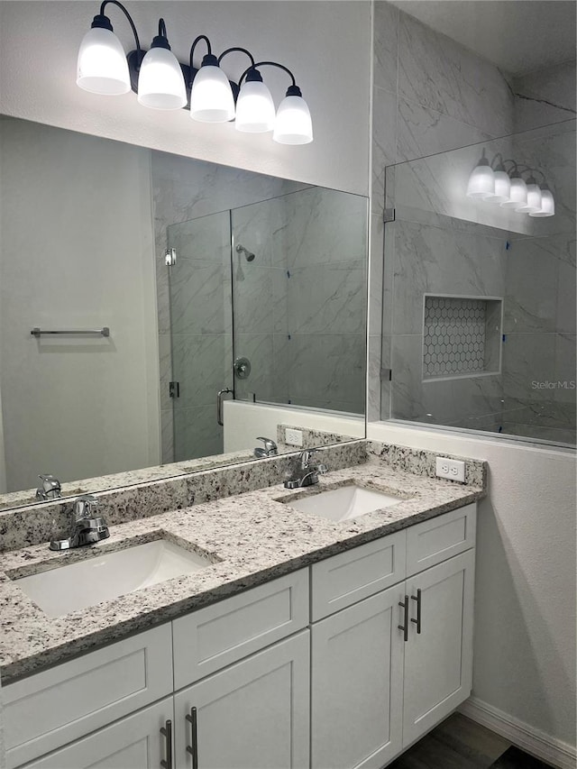 bathroom featuring vanity and a shower with shower door