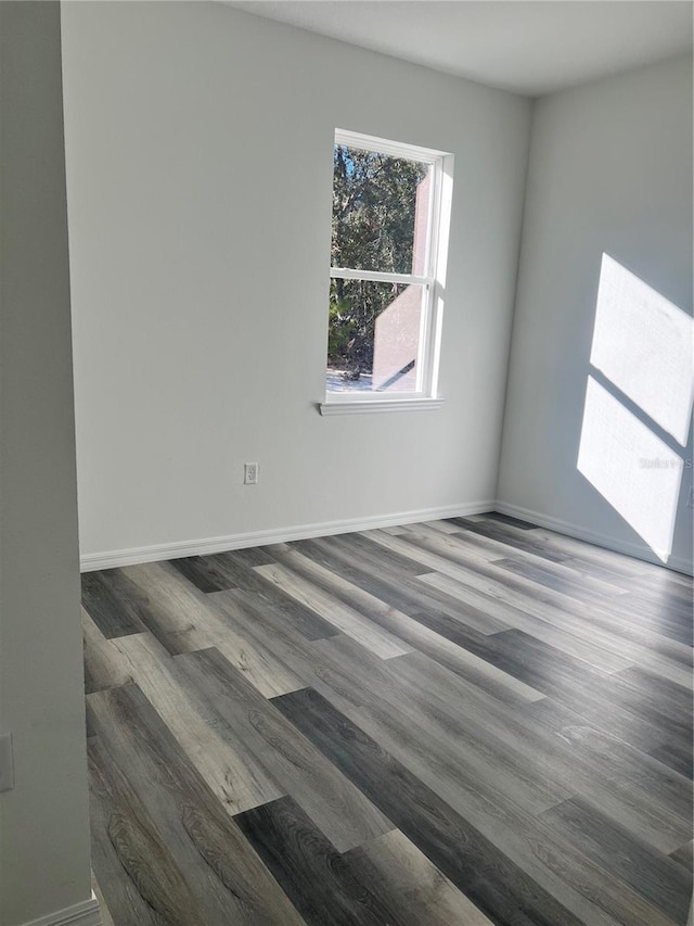 empty room with dark hardwood / wood-style flooring