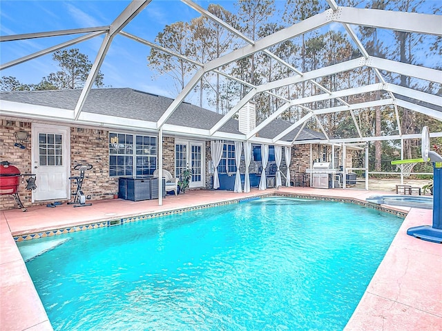 view of pool with a lanai, french doors, and a patio