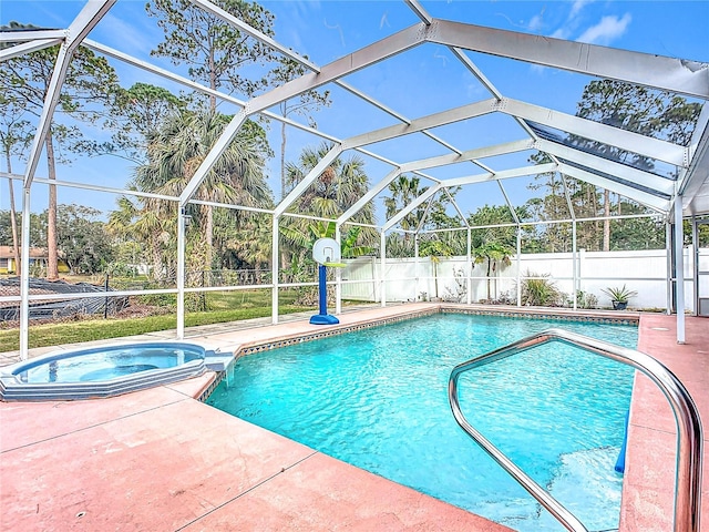 view of pool with an in ground hot tub, a patio area, and a lanai