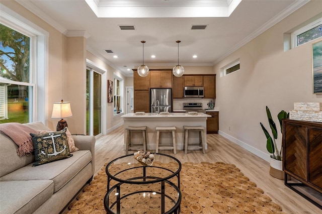 12133 Grand Oak Ln, Oxford, FL 34484 - living room featuring light wood-type flooring and ornamental molding