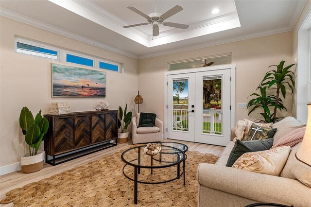 12133 Grand Oak Ln, Oxford, FL 34484 - living room with french doors, light wood-type flooring, crown molding, and a healthy amount of sunlight