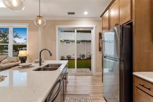12133 Grand Oak Ln, Oxford, FL 34484 - kitchen with stainless steel appliances, light hardwood / wood-style floors, a healthy amount of sunlight, and sink