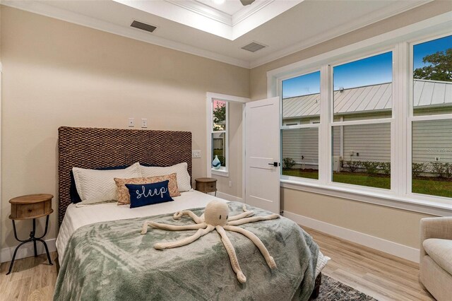 12133 Grand Oak Ln, Oxford, FL 34484 - bedroom with light hardwood / wood-style flooring, multiple windows, and ornamental molding