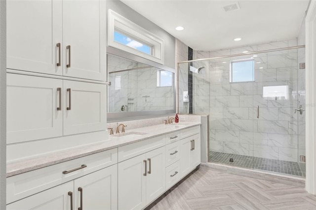 full bathroom featuring recessed lighting, a sink, visible vents, a shower stall, and double vanity