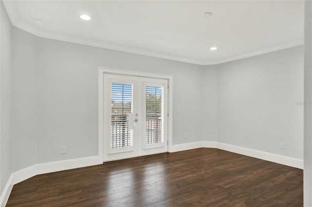 spare room featuring dark wood-style floors, baseboards, ornamental molding, and french doors