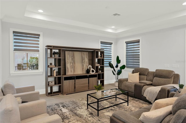 living room featuring recessed lighting, a raised ceiling, visible vents, light wood-style floors, and baseboards