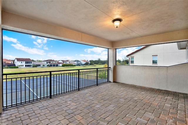 view of patio with a residential view and a balcony