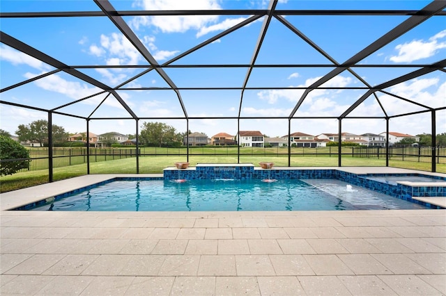 view of pool featuring glass enclosure, a residential view, a yard, a patio area, and a pool with connected hot tub