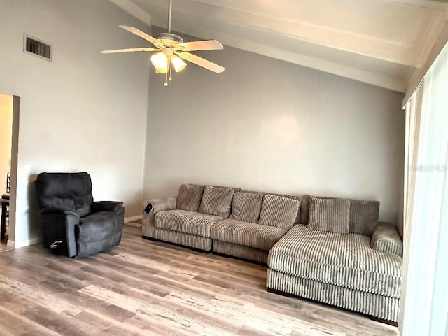 living room with ceiling fan, light hardwood / wood-style floors, and vaulted ceiling