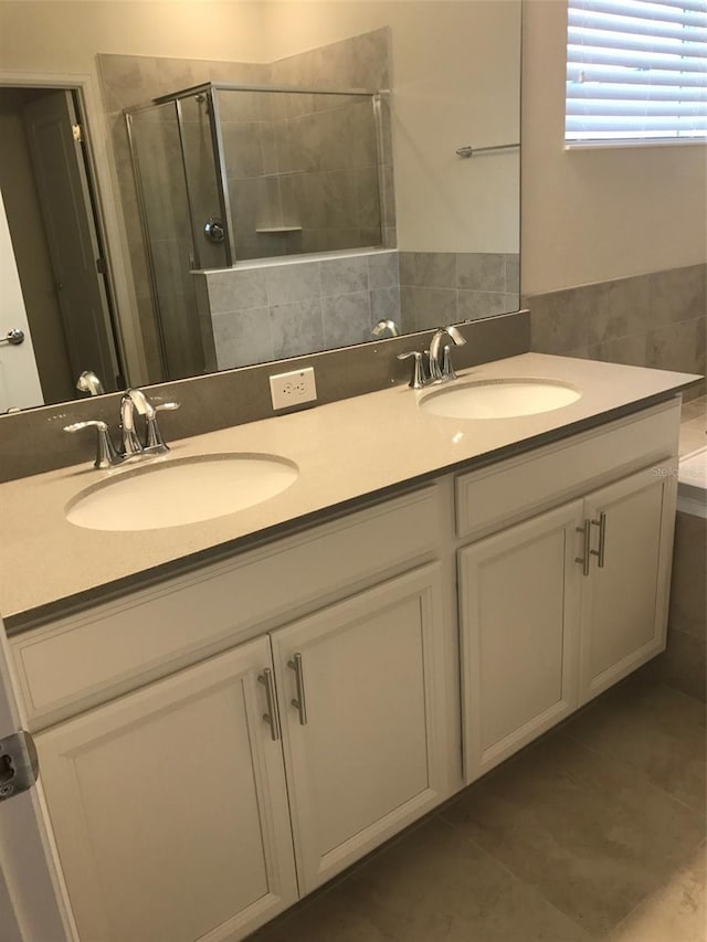 bathroom with tile patterned floors, vanity, and an enclosed shower