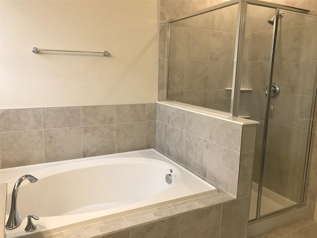 bathroom with shower with separate bathtub