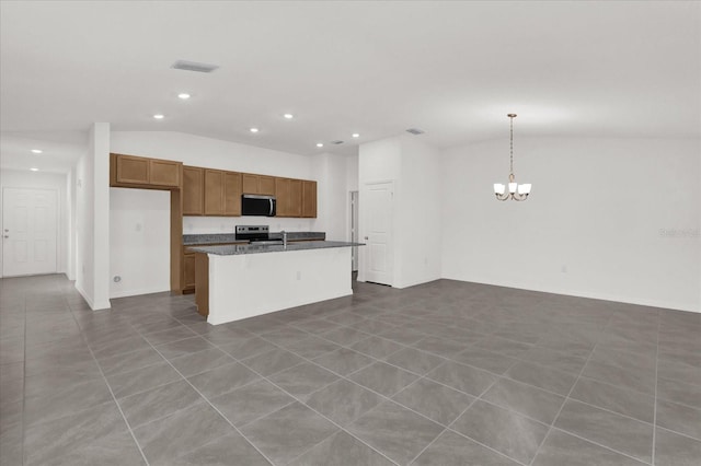 kitchen with a center island, brown cabinets, hanging light fixtures, appliances with stainless steel finishes, and open floor plan