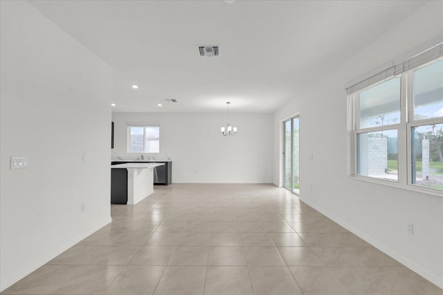 spare room with a chandelier, light tile patterned floors, recessed lighting, visible vents, and baseboards