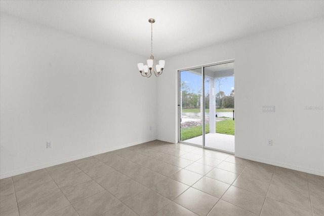 empty room with a chandelier, baseboards, and light tile patterned floors