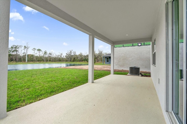 view of patio with a water view and central air condition unit