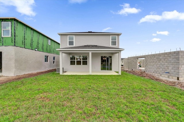 rear view of house featuring a lawn, a patio area, cooling unit, and a fenced backyard