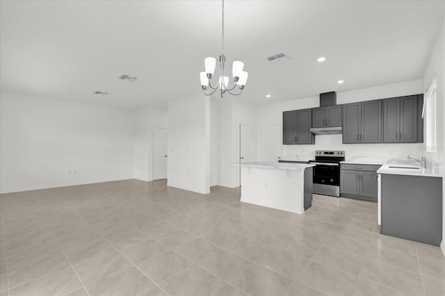 kitchen featuring under cabinet range hood, light countertops, stainless steel electric range oven, and visible vents